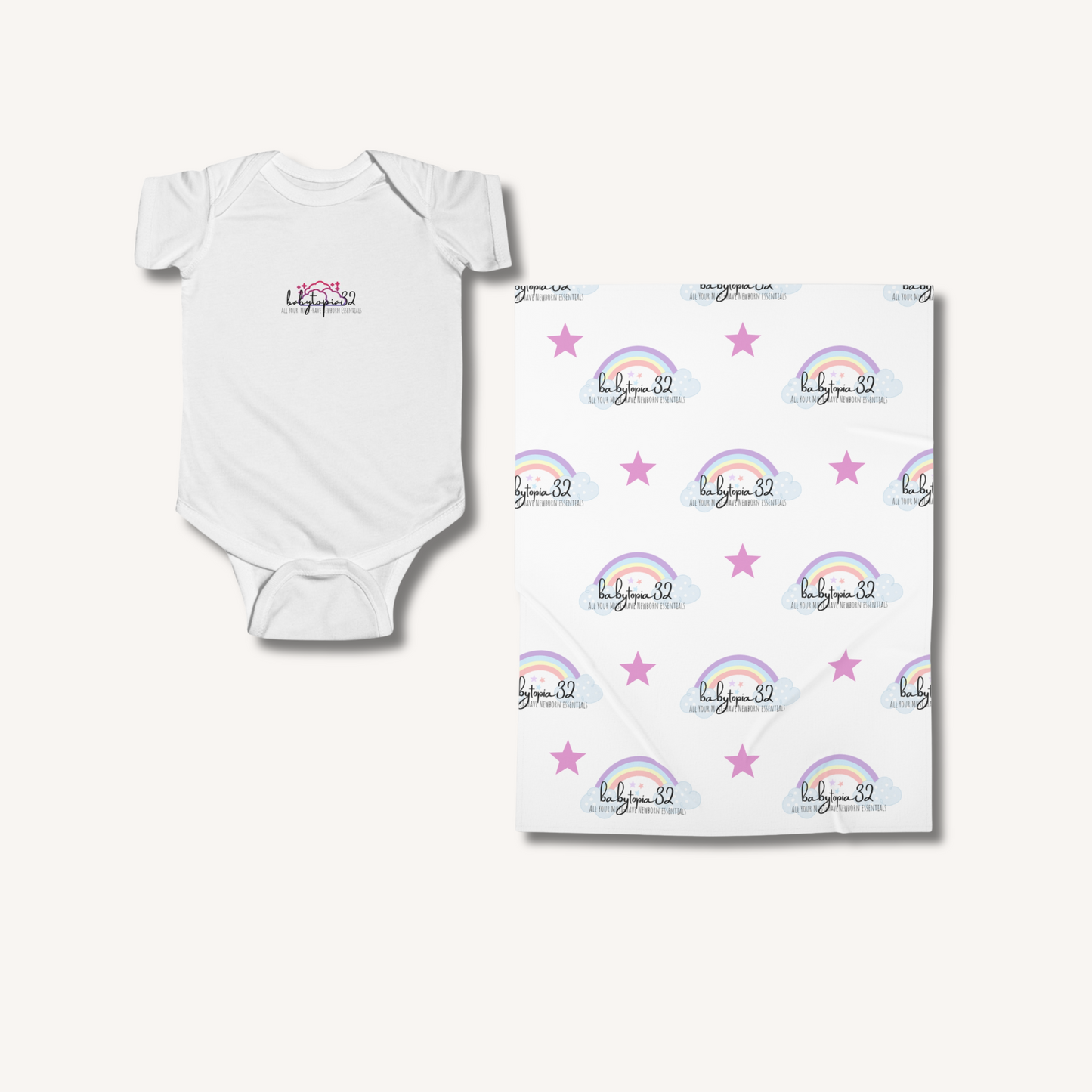 White baby onesie and matching blanket with rainbow and star pattern on a white background