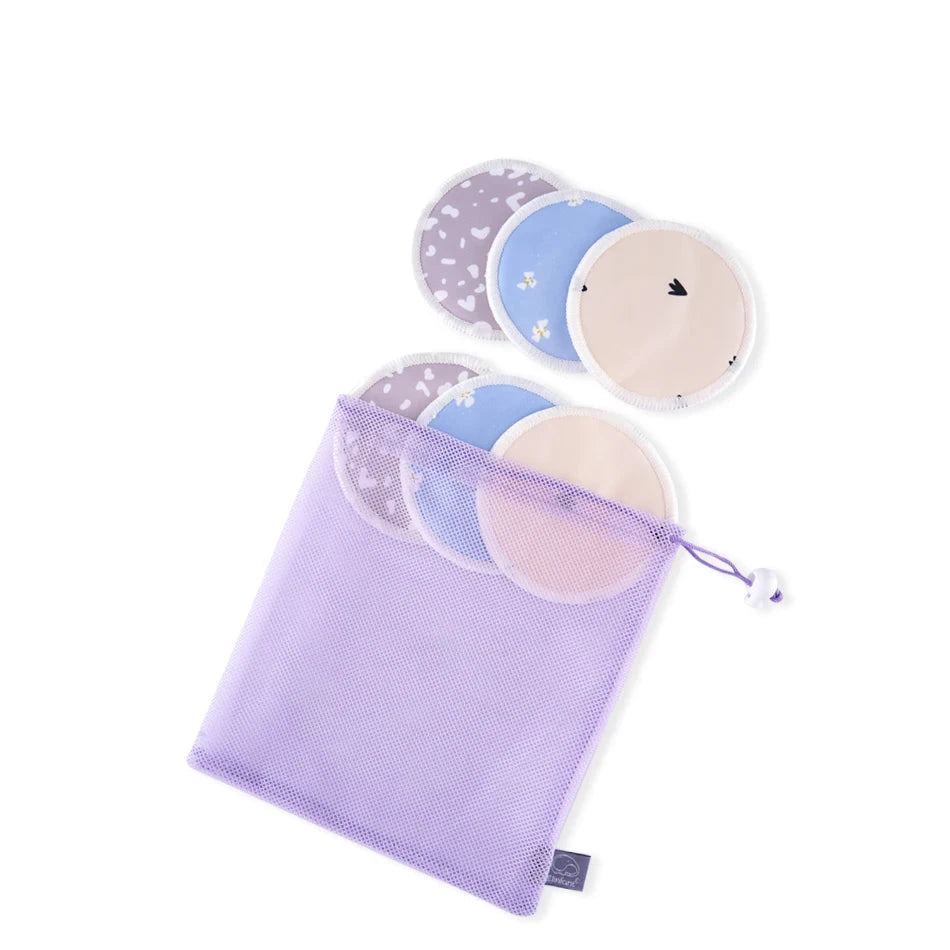 A lavender mesh drawstring pouch containing three round reusable pads in different colors and patterns, with three more pads shown above the pouch. A gray label at the top reads ES067-K.
