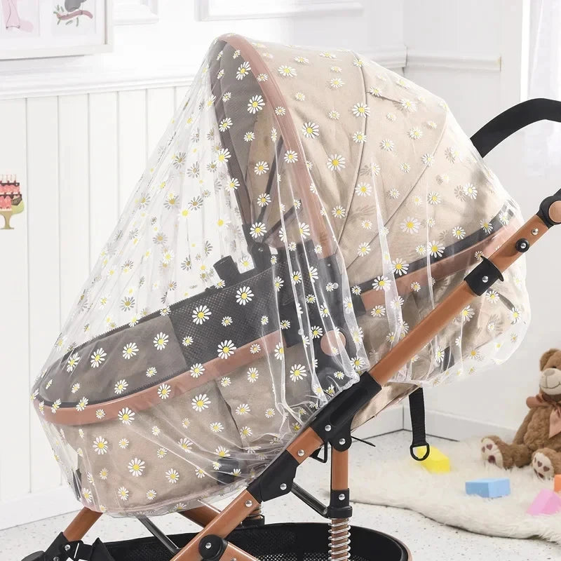 Baby stroller with a floral canopy in a room with toys on the floor.