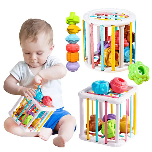 Baby playing with colorful developmental toys on a white background