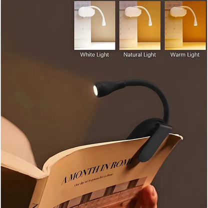 Booklight illuminating a book with three light options displayed above.