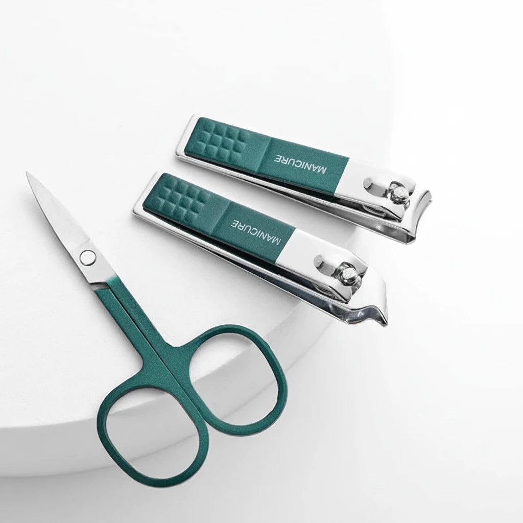 Set of nail clippers with green handles on a white background